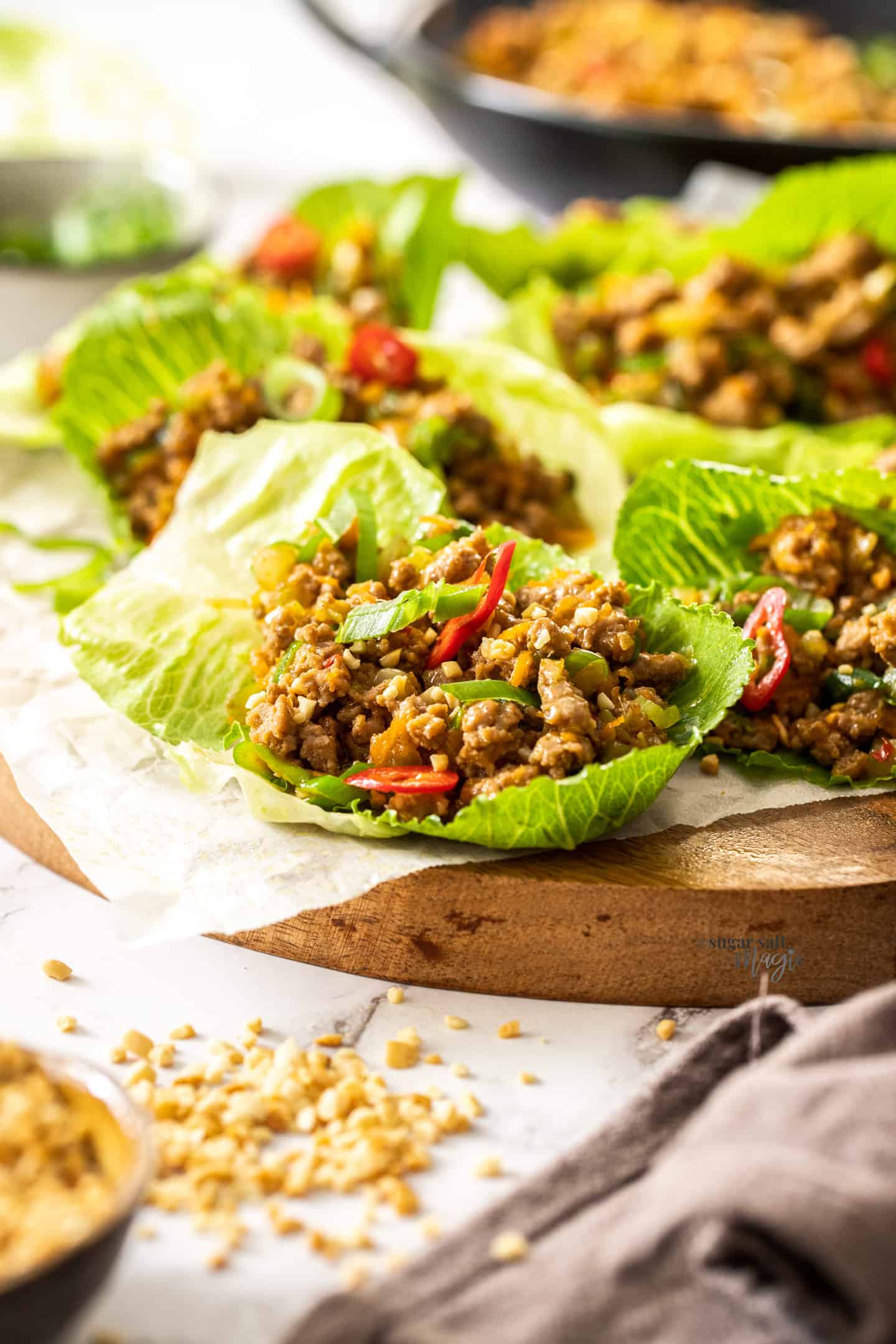 Chinese lettuce wraps on a wooden board.