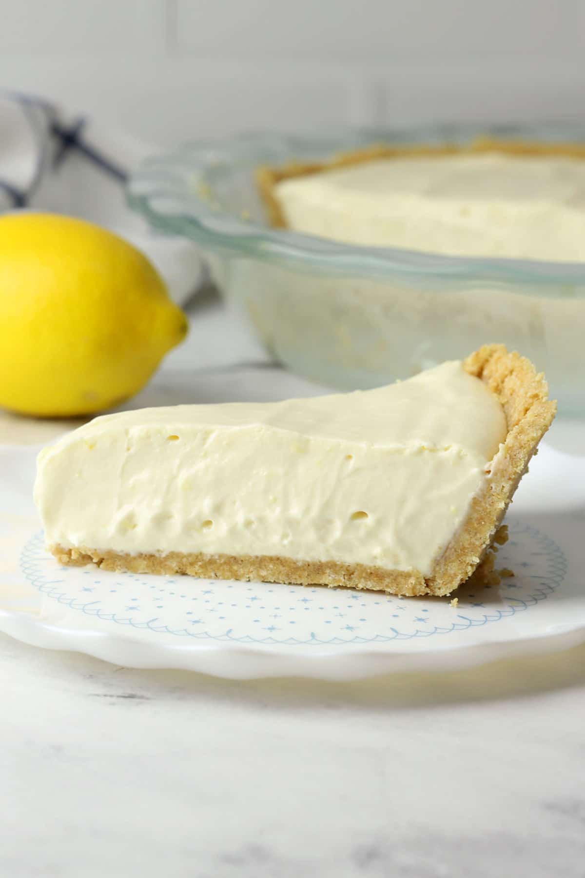 Slice of lemon ice box cake on a white plate.