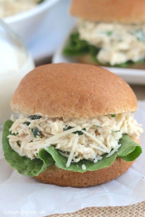 Crockpot chicken Caesar sandwich on a parchment paper.