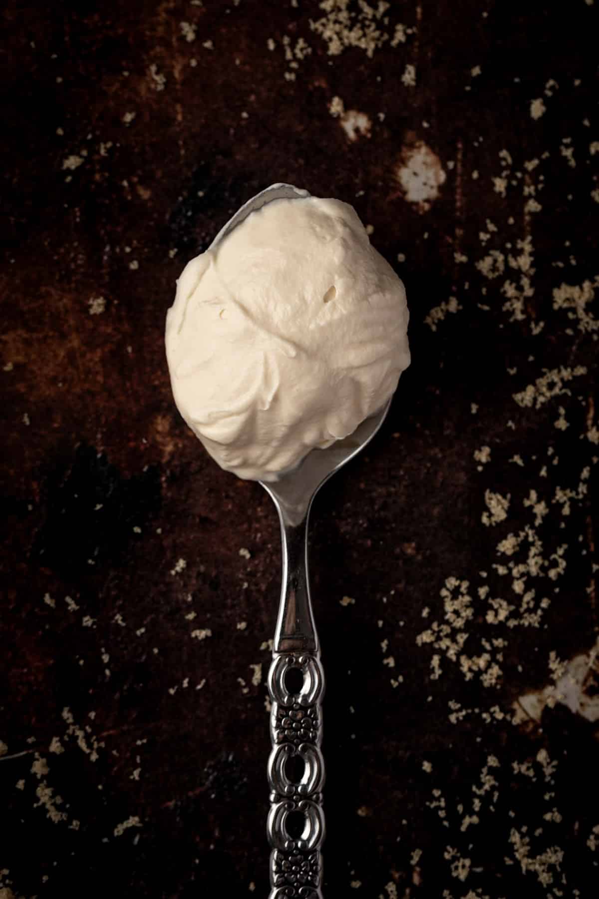 Brown sugar whipped cream on a spoon.