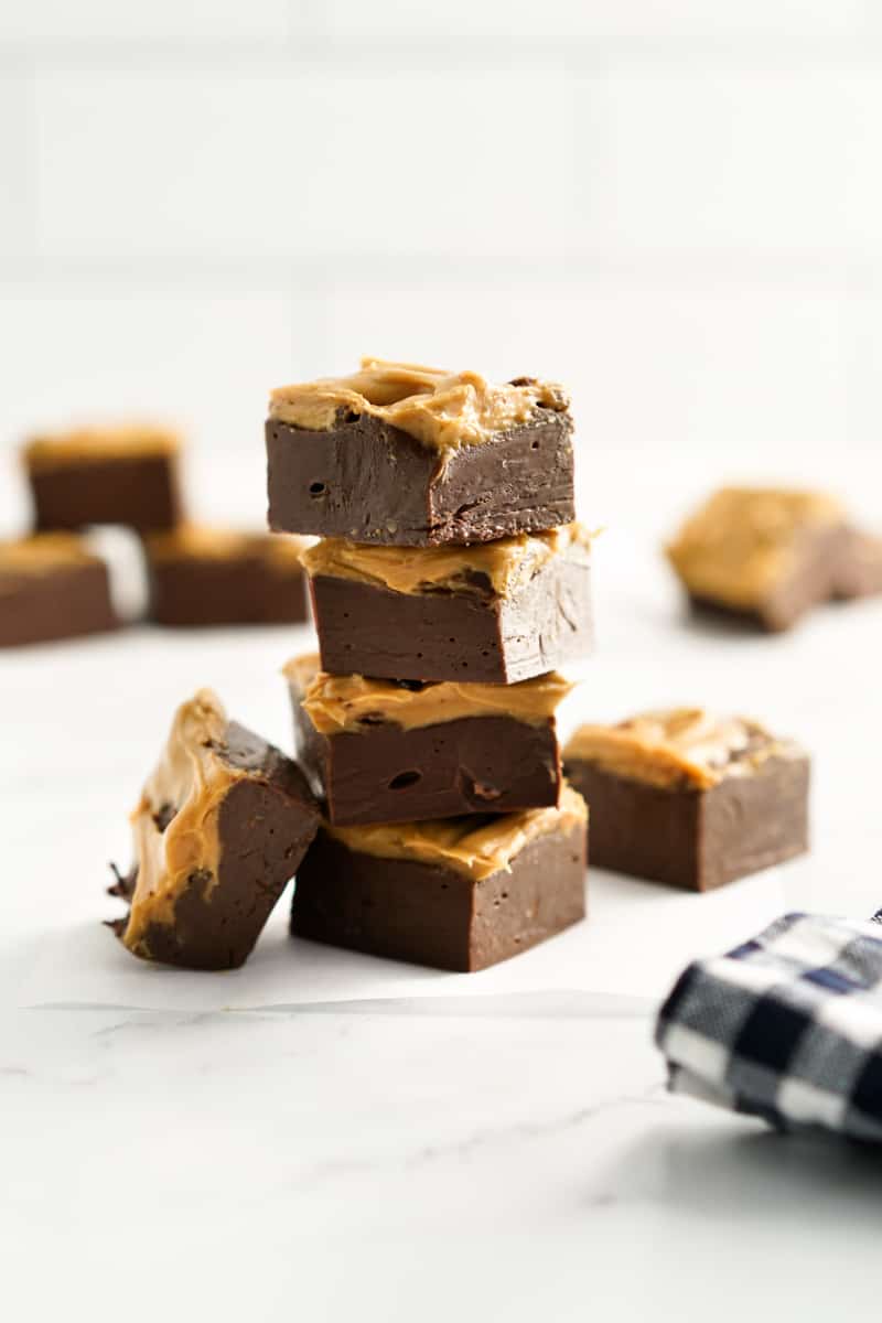 Chocolate peanut butter fudge pieces stacked.