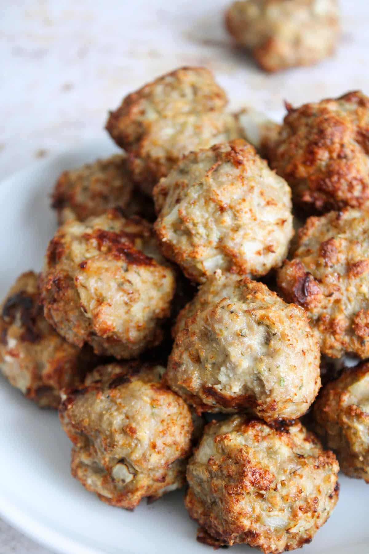 Stacked air fryer turkey meatballs on a plate.