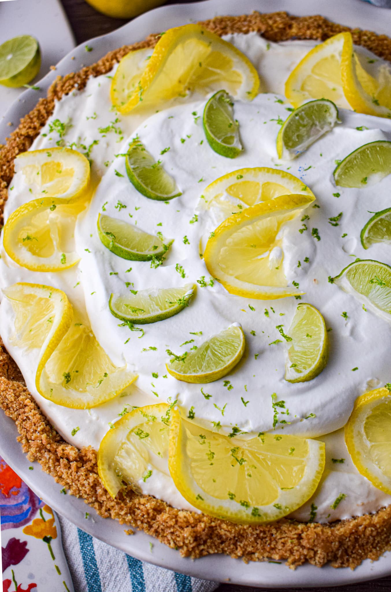 Lemon lime ice box pie with lemon and lime slices.