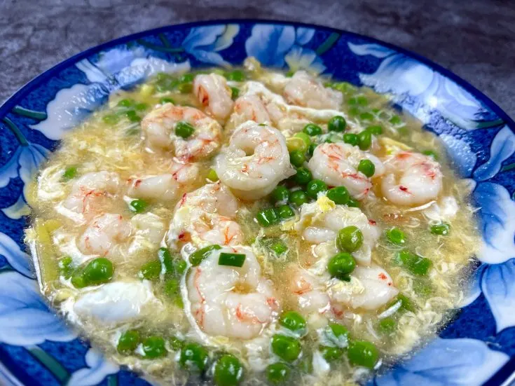 Shrimp in lobster sauce in a blue bowl.