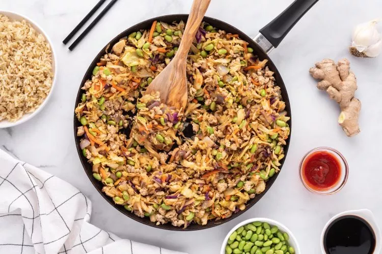 Ground chicken and veggie mix in a skillet.