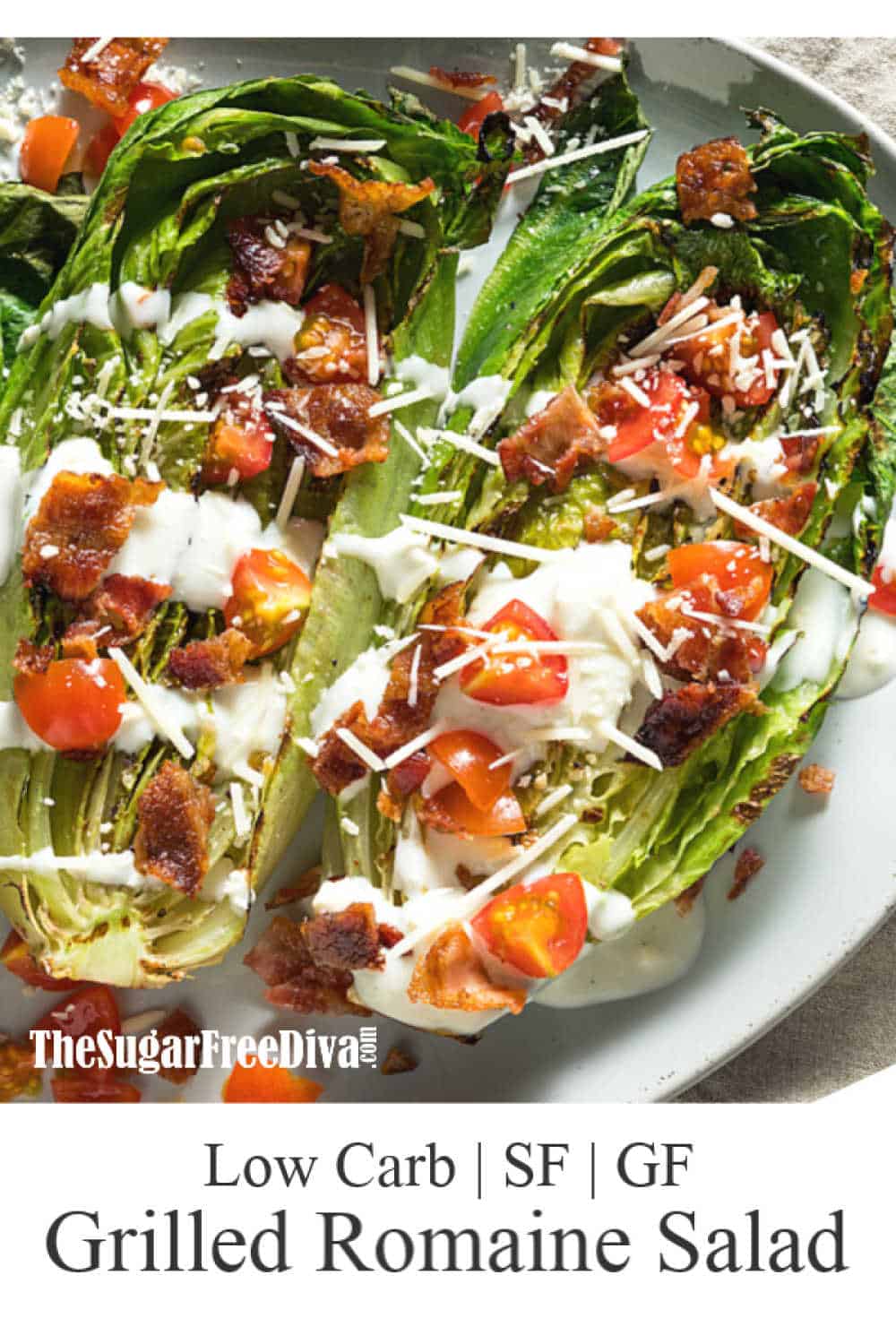 Grilled romaine lettuce with salad dressing, diced tomatoes, bacon, and parmesan cheese on a plate.