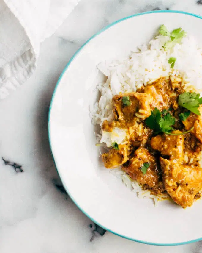 Pork vindaloo curry on a white plate.