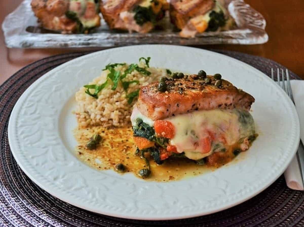 Stuffed pork chops on a white plate.