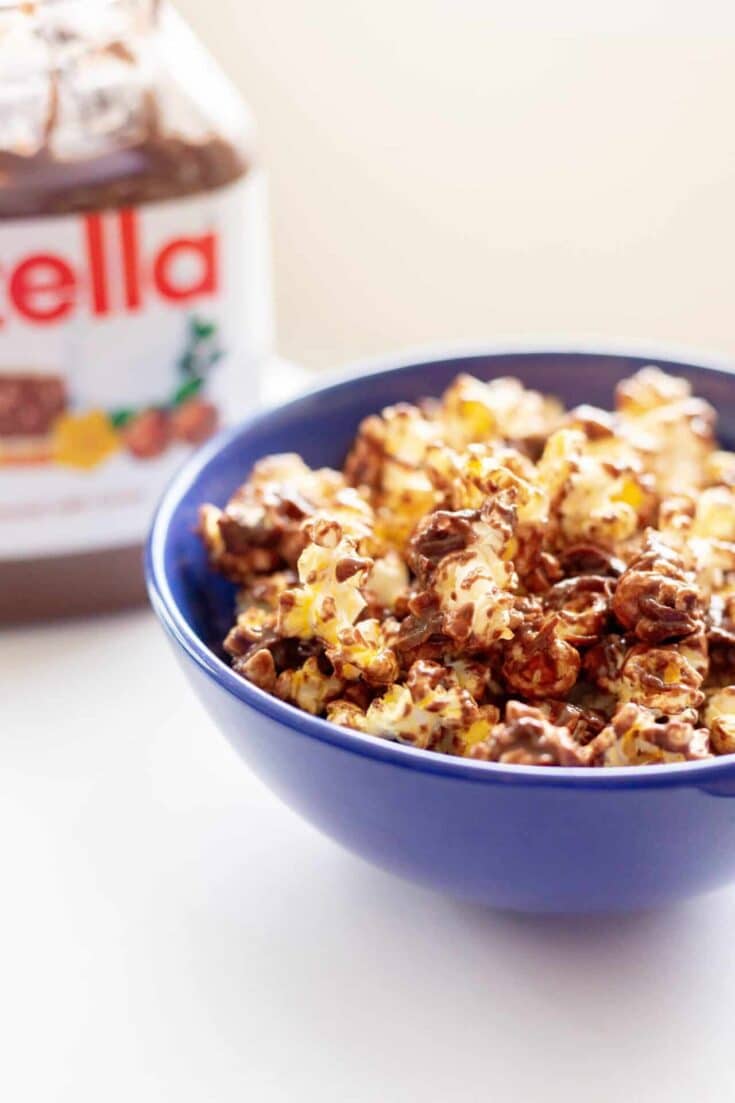 Coconut Nutella popcorn in a blue bowl.