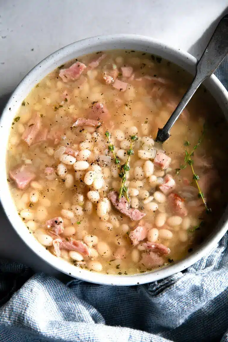 Navy bean soup with ham in a bowl with a soup.