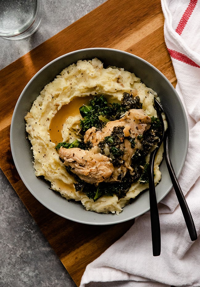 Instant pot lemon garlic chicken in a bowl with forks.