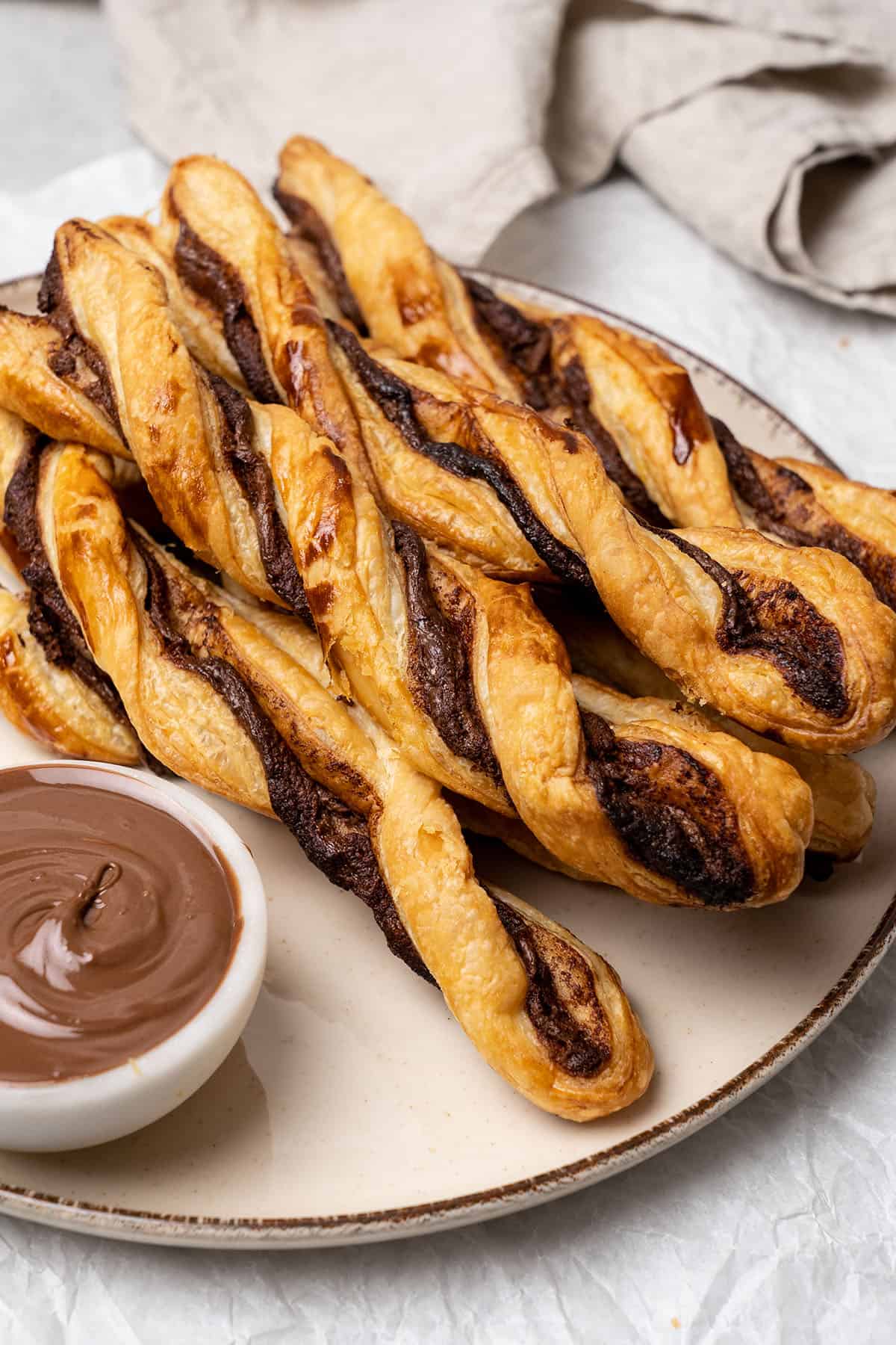 Plate full of puff pastry twist with Nutella.