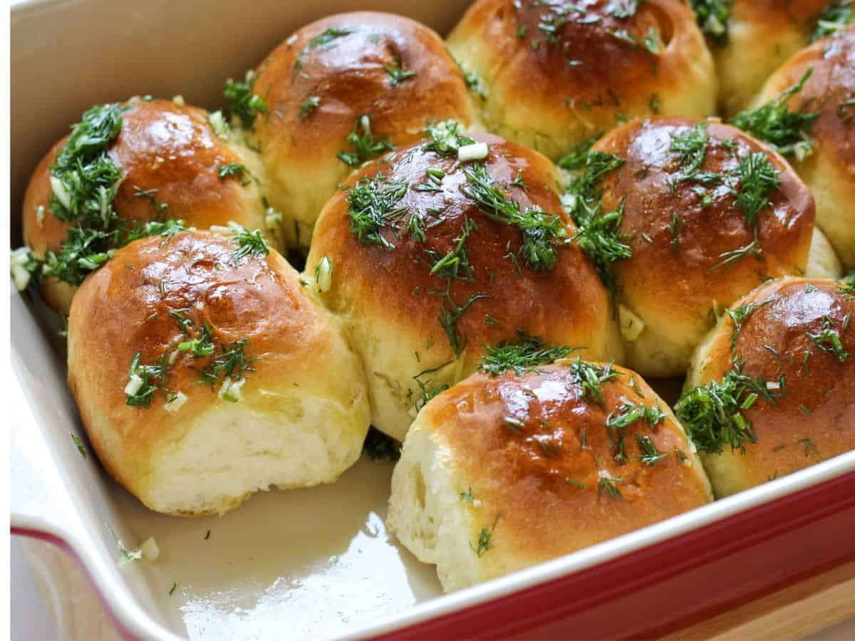 Ukrainian dinner rolls in a red baking dish.