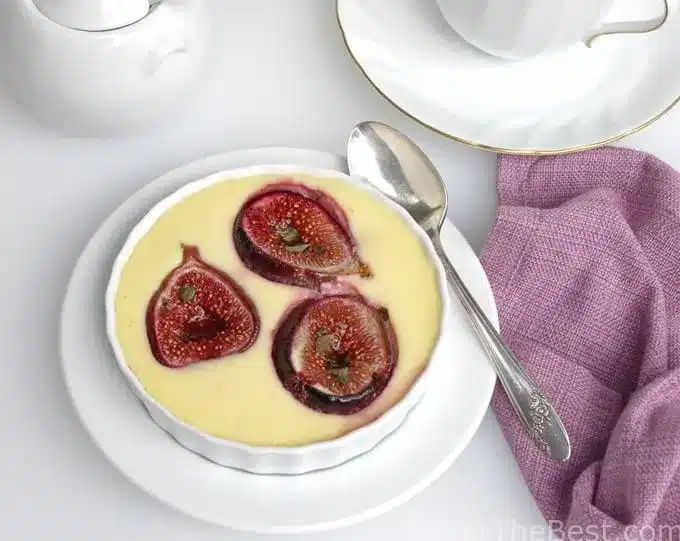 Roasted figs in goat cheese custard on a plate.