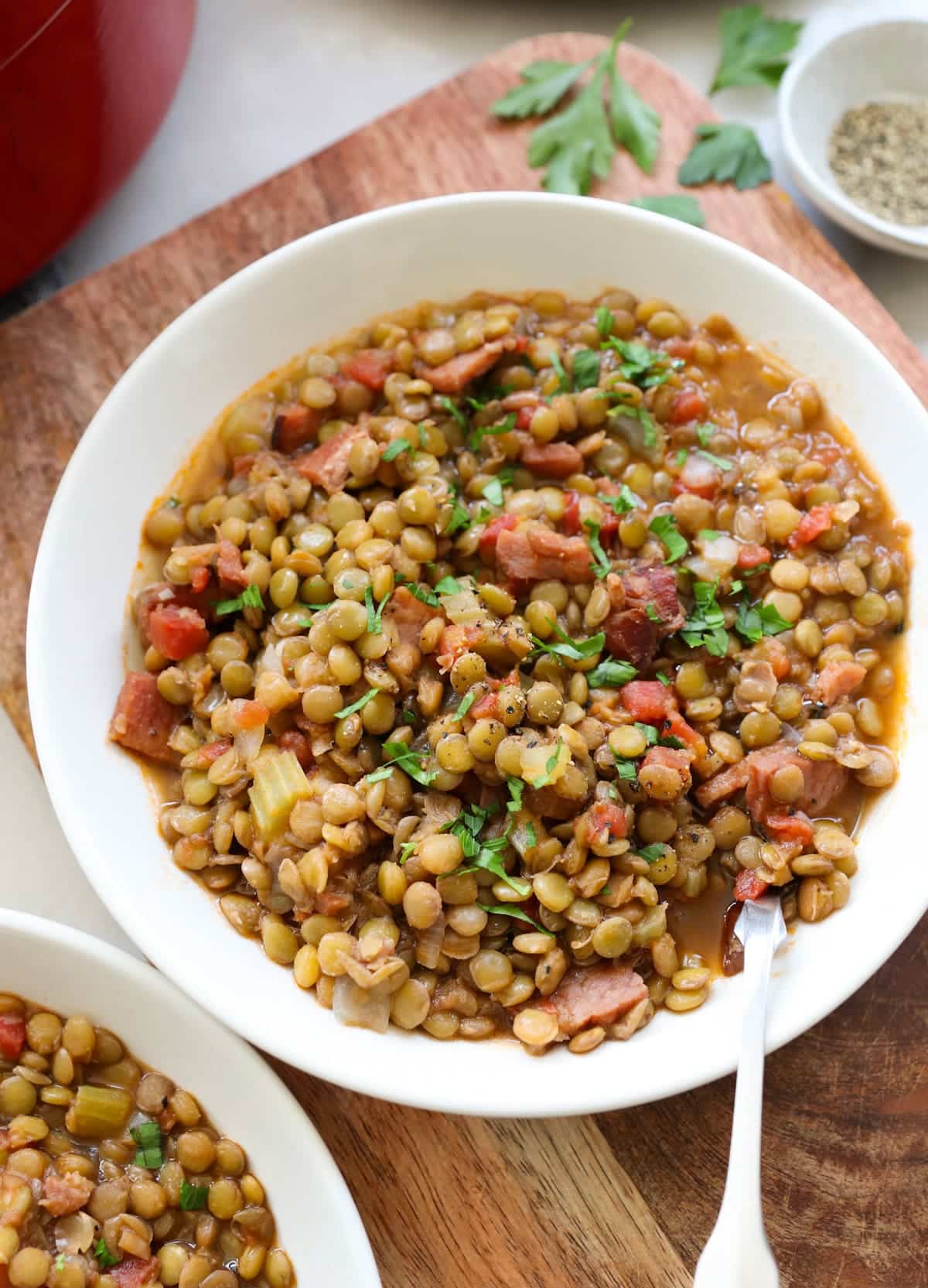 Lentil and ham soup in a white bowl.