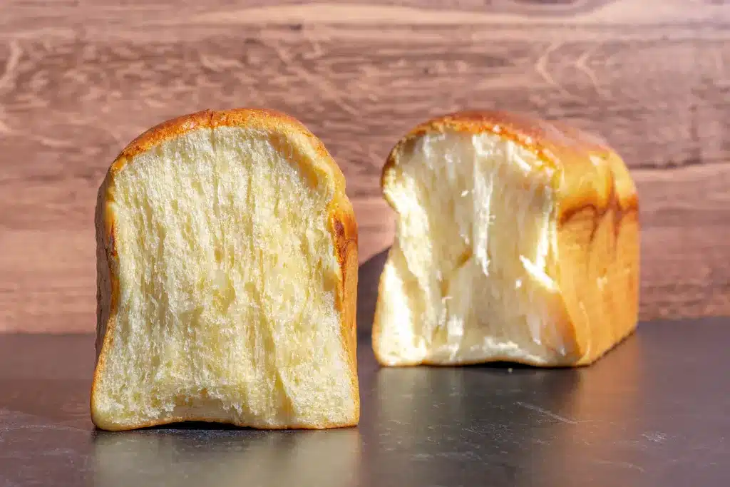 Sourdough brioche bread on a black background.