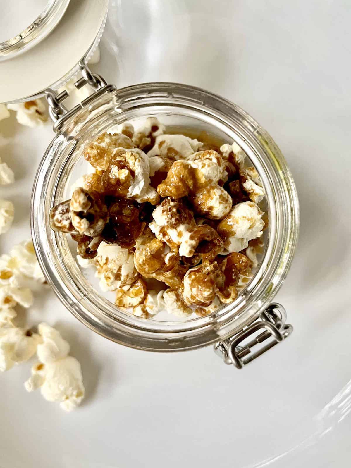 Soy sauce butter popcorn in clear jar.