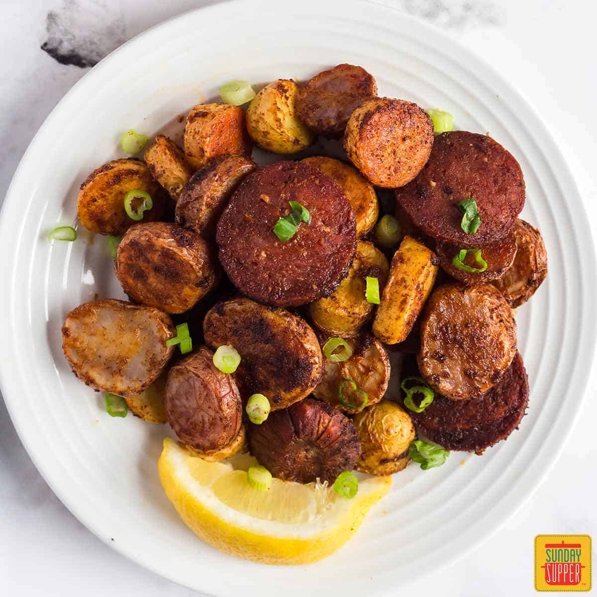 Portuguese potatoes and chorizo on white plate.