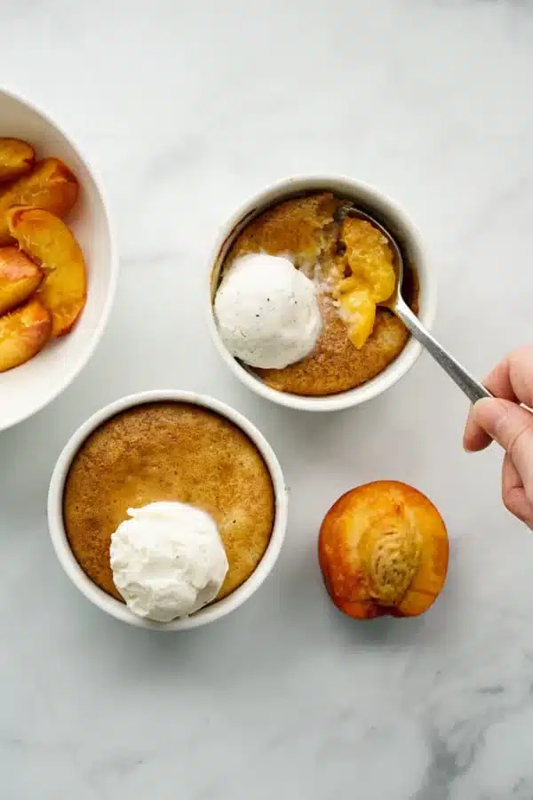 Individual mini peach cobbler in ramekins.