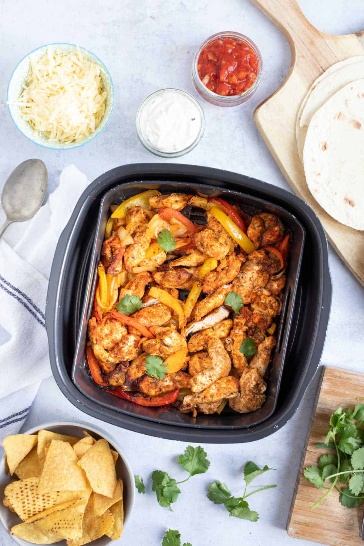 Air fryer chicken fajitas in an air fryer basket.