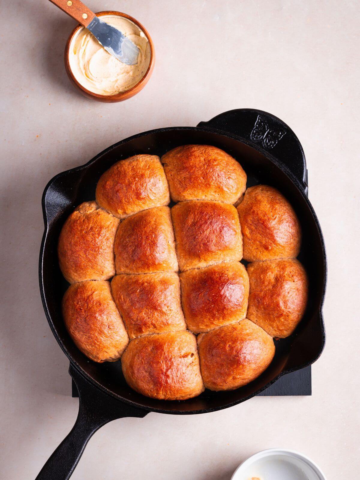 Banana yeast bread rolls in a cast iron pan.