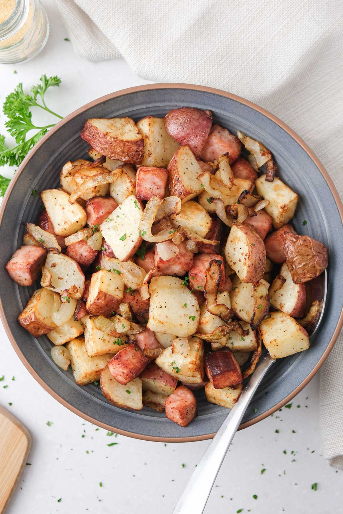 Air fryer ham and potatoes in a bowl.