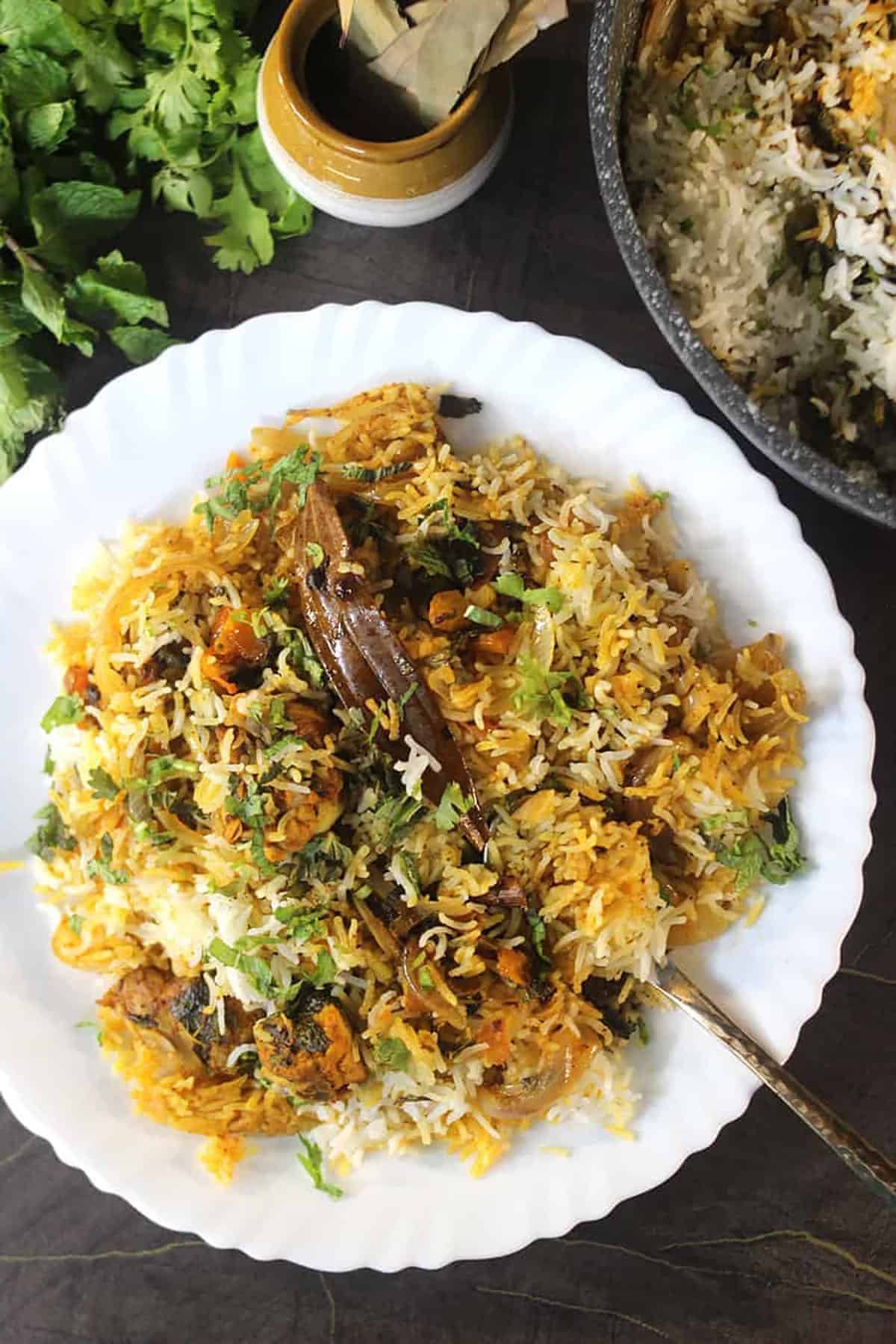 Chicken biryani on a white plate.