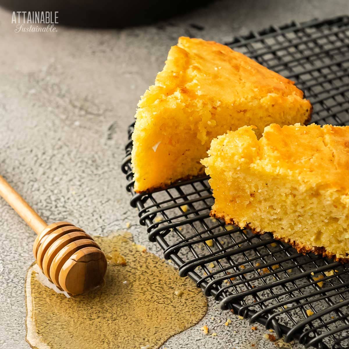Slices pieces of sweet cornbread on a cooling rack.