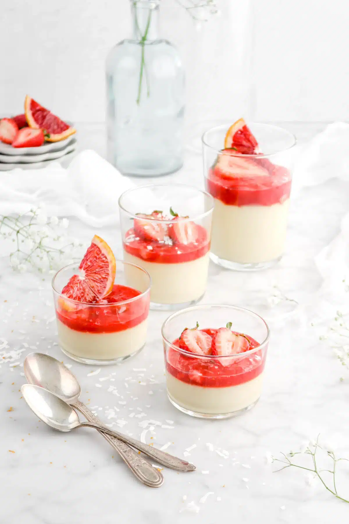 Coconut custard with strawberry rhubarb compote in dessert glasses.