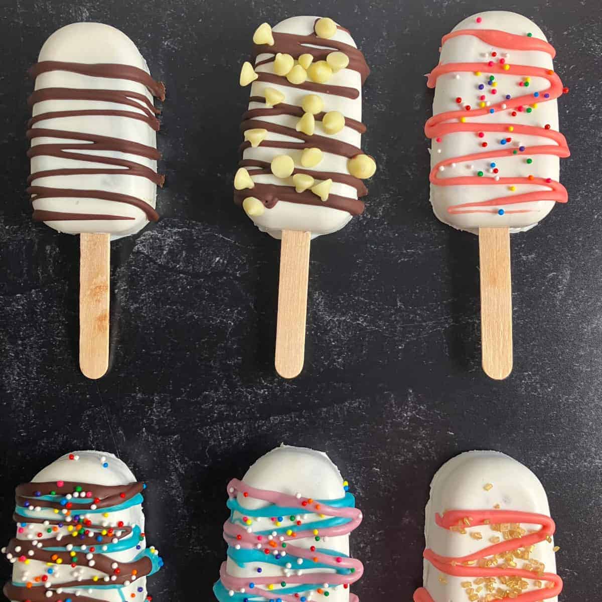 Cake pops on a black countertop.