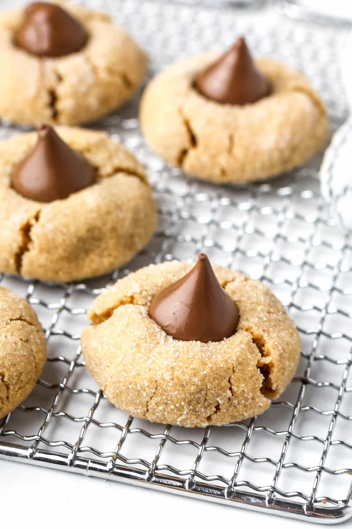 Three ingredient peanut butter blossoms on a cooling rack.