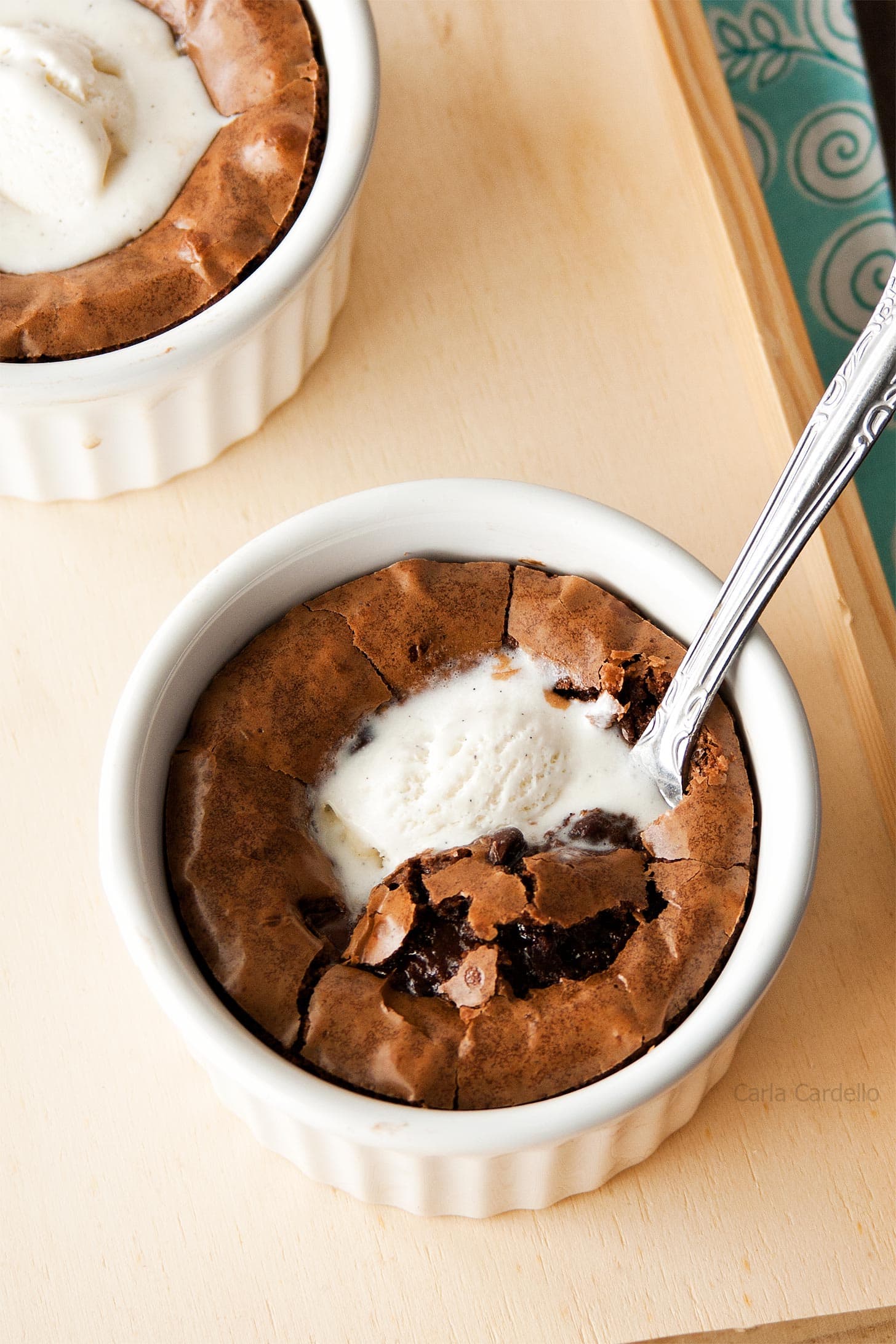 Brownies with scoop of ice cream in white ramekins.