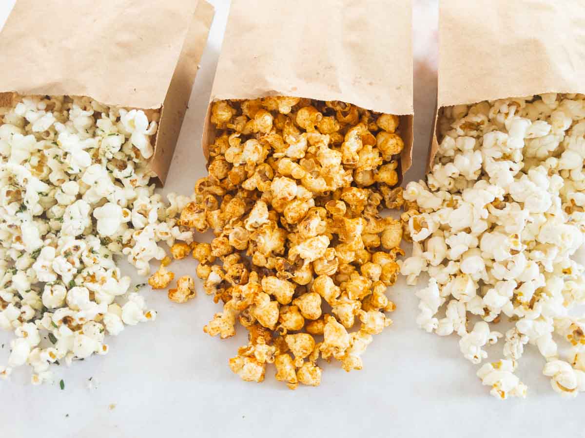 Duck fat popcorn in brown paper bags.