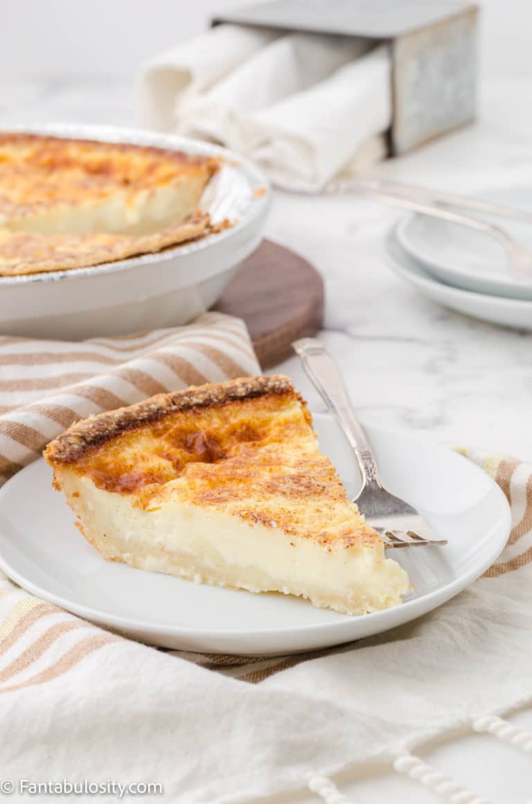 Slice of old fashioned egg custard with rest in the background.