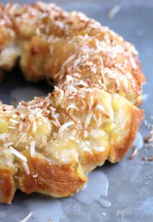 Pina colada monkey bread on a dark surface.