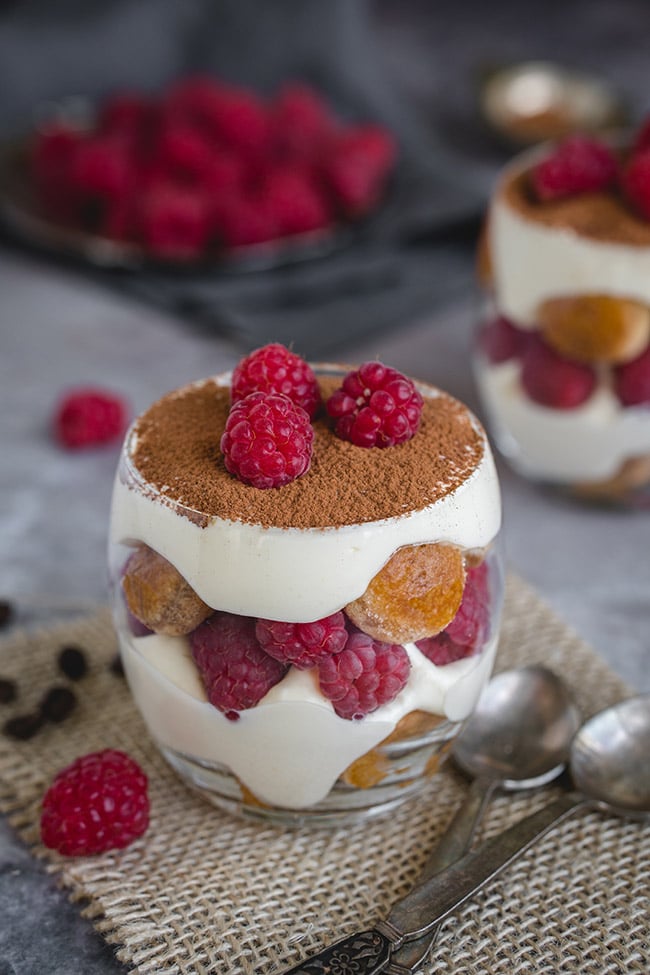 Raspberry tiramisu with spoons in the background.