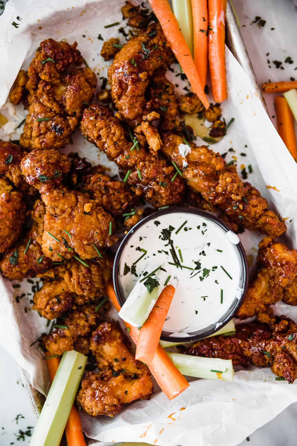 Air fryer sticky chicken wings with carrots, celery and sauce.