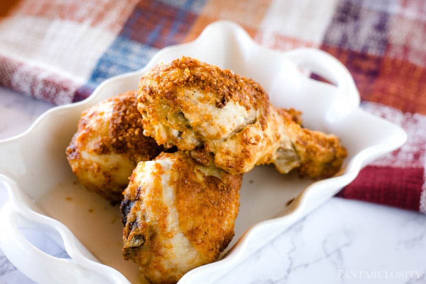 Air fryer chicken legs on a white tray.