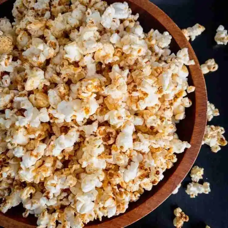 Browned butter brown sugar homemade kettle corn in a wooden bowl.