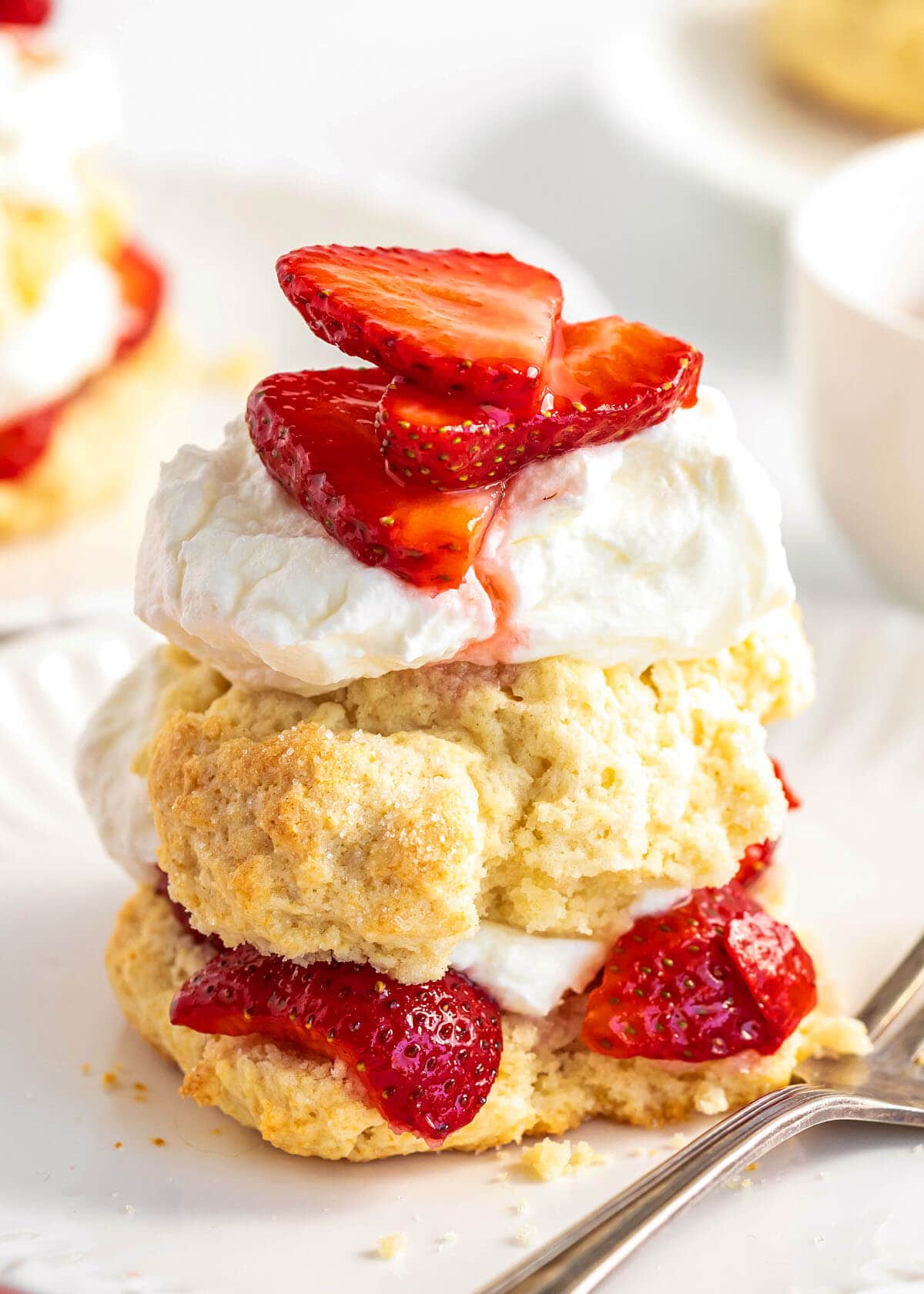 Old fashioned strawberry shortcake with whipped cream and strawberries on top.