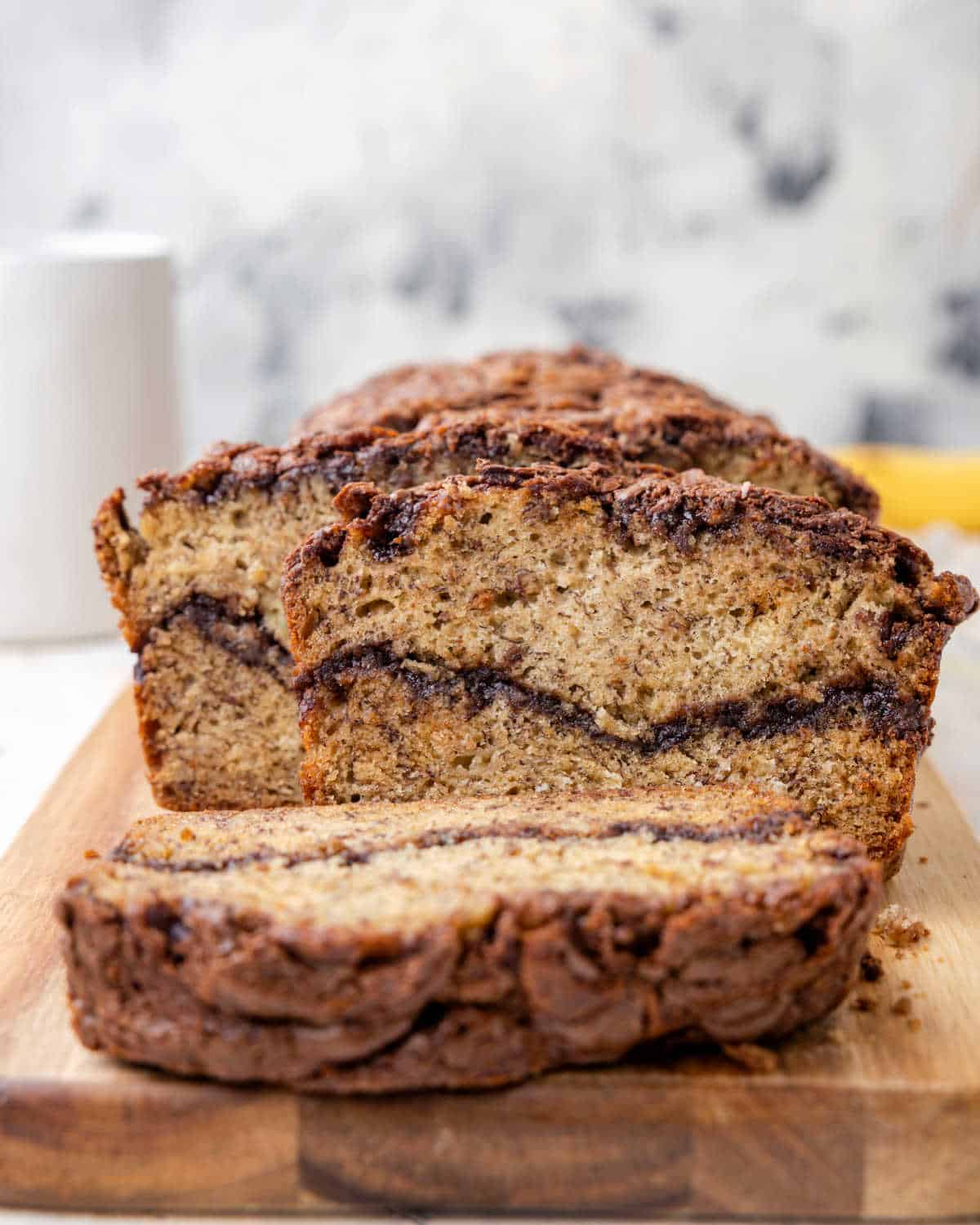 Sliced banana bread with Nutella chocolate sauce.