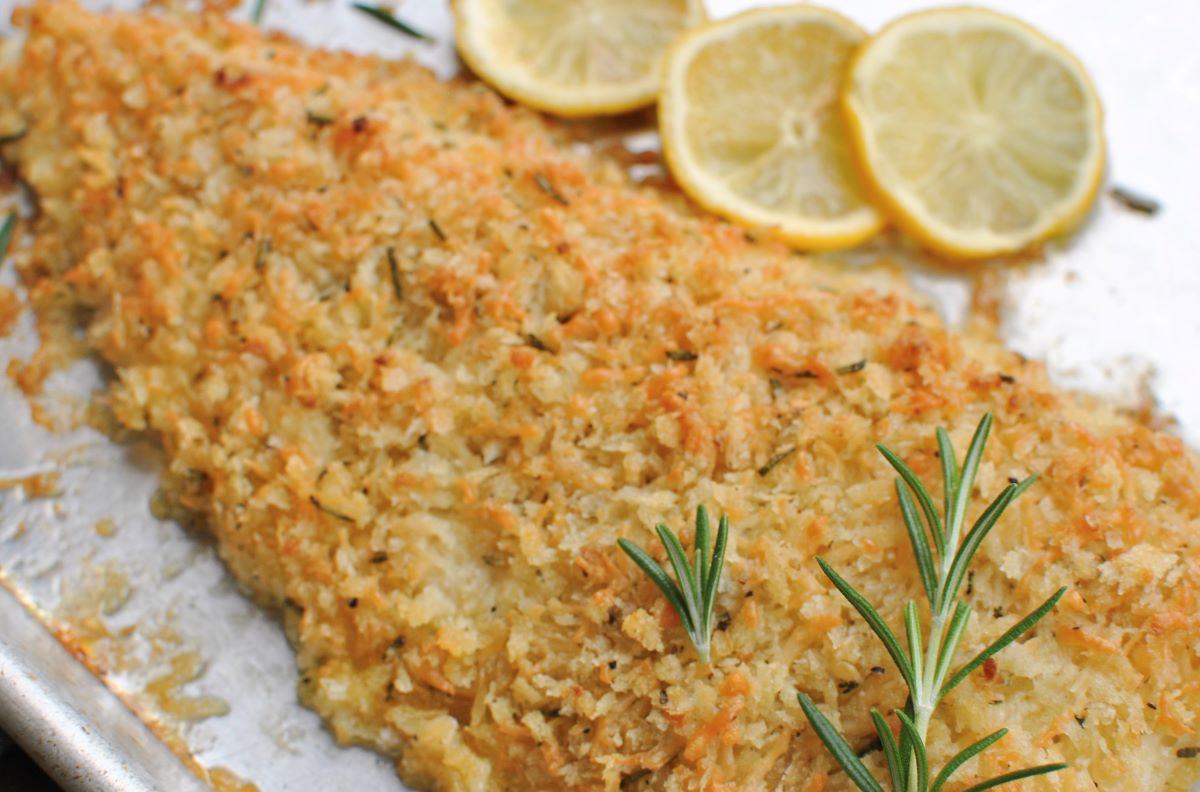 Rosemary parmesan crusted fish with lemon slices.