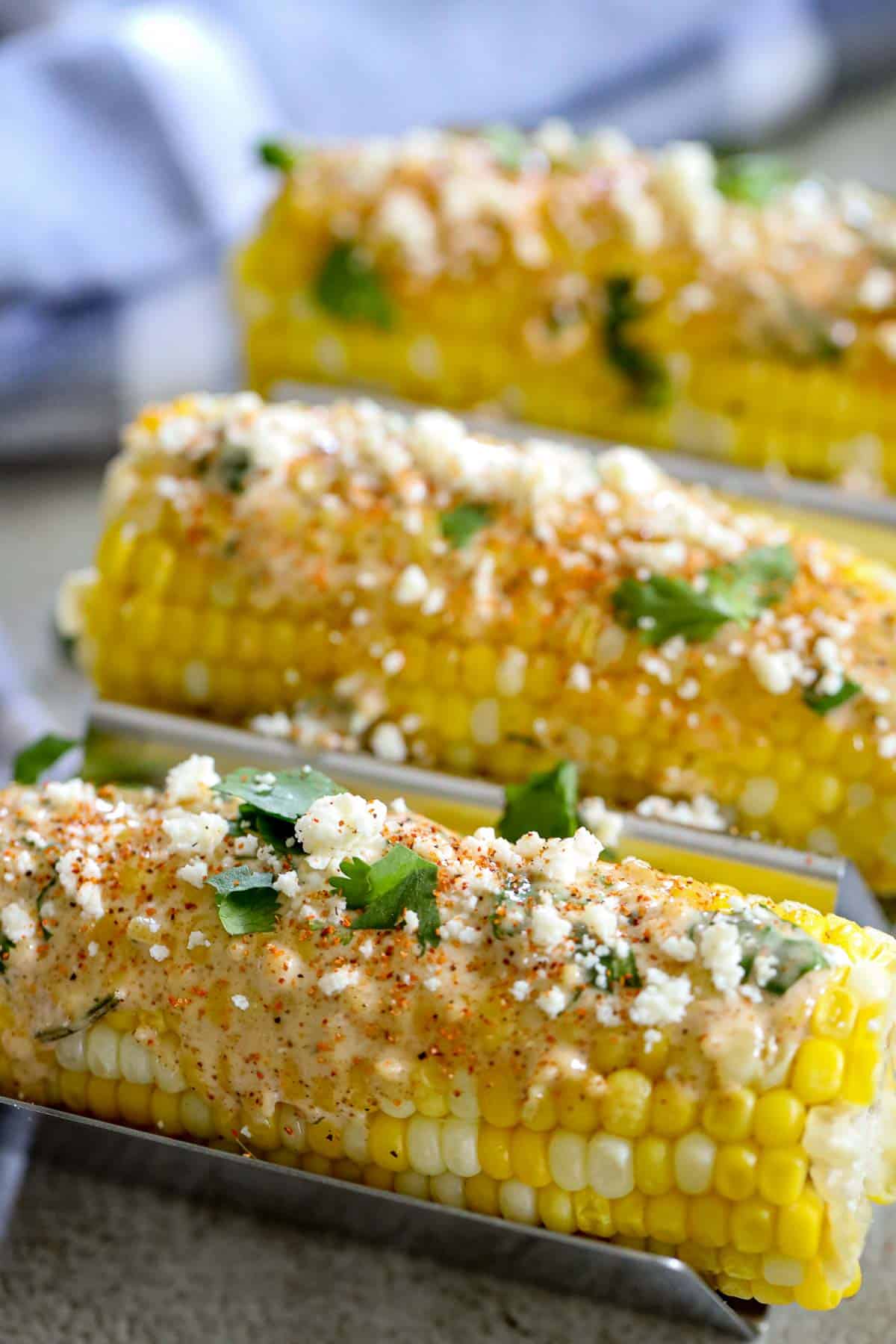 Mexican street corn on serving racks.