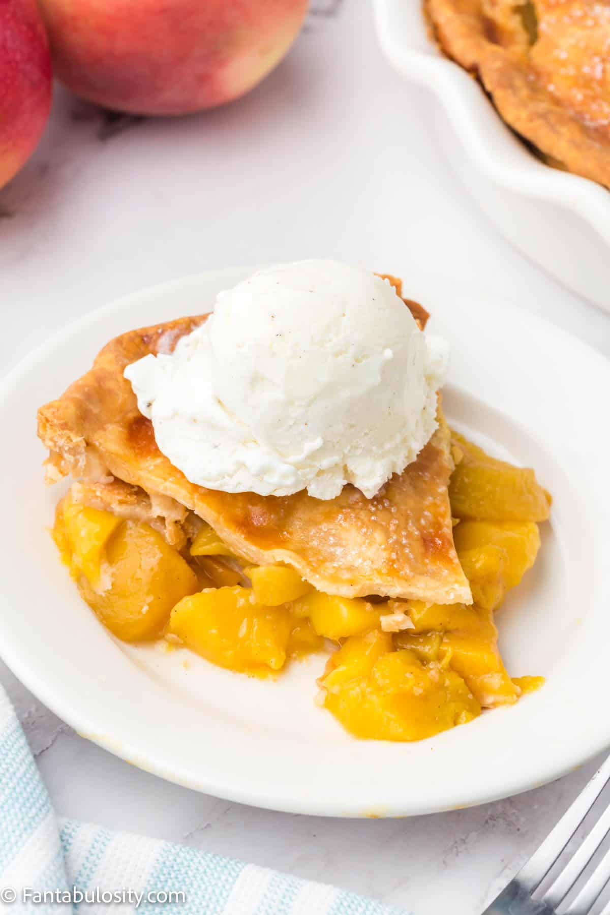 Slice of peach mango pie on a plate.