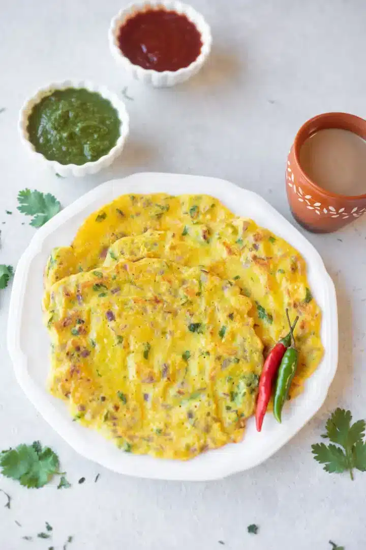 Lentil pancakes with peppers on a white plate.