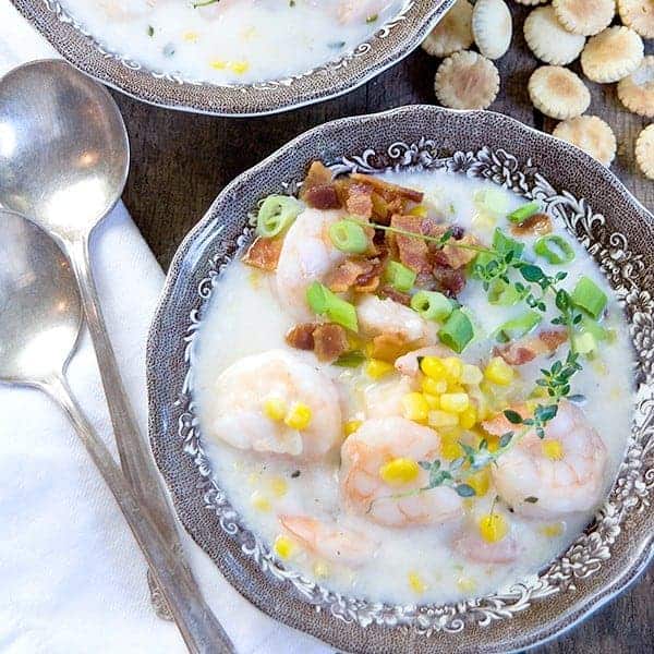 Shrimp and corn chowder in a fancy bowl.