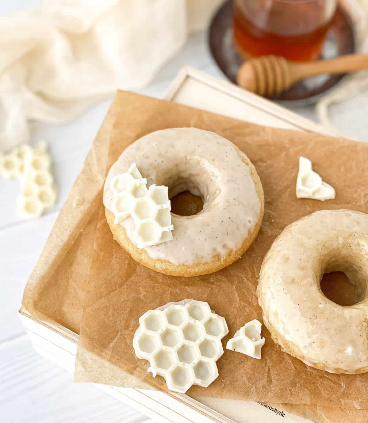 Honey donuts with vanilla honey glaze on parchment paper.