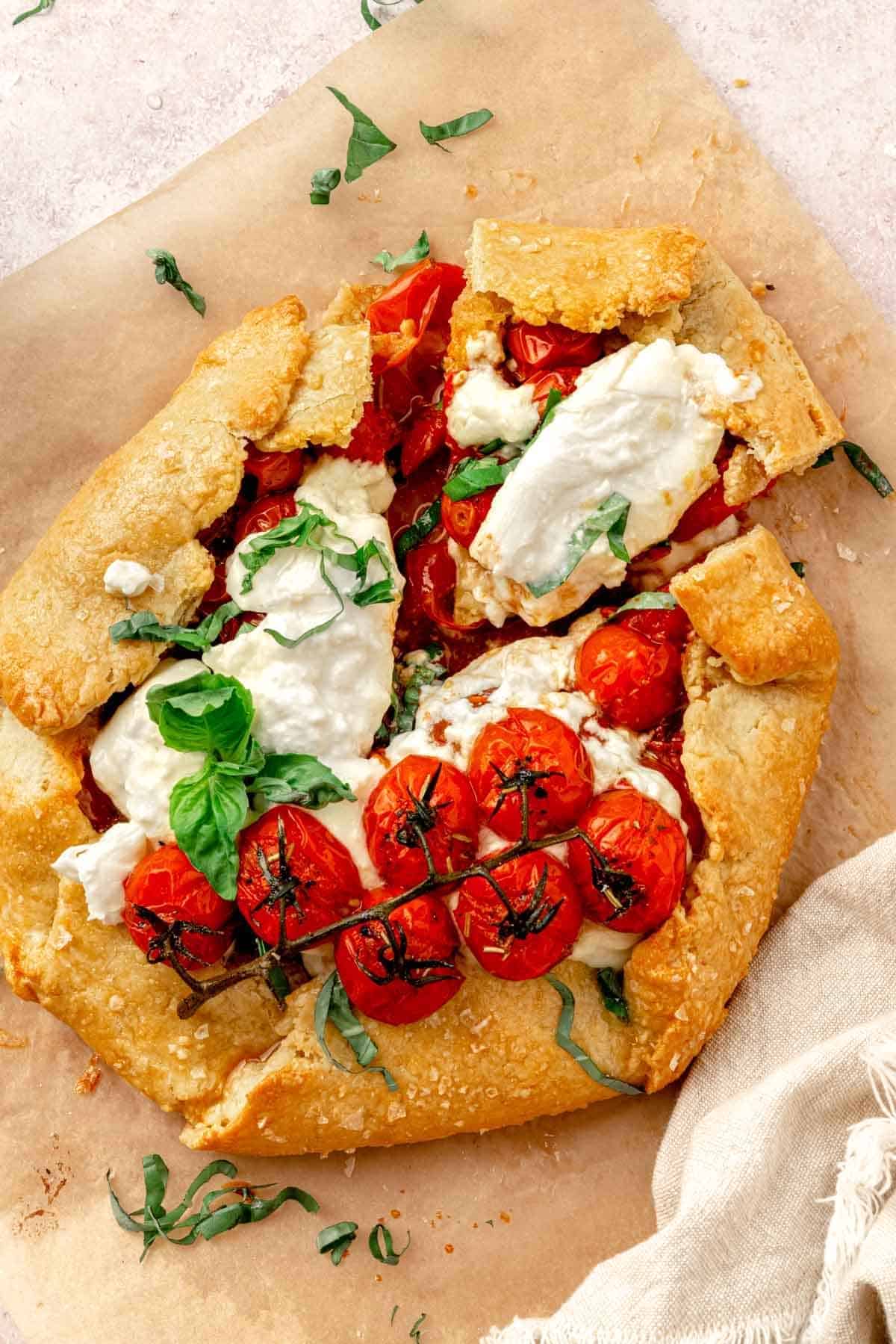 Tomato galette on a piece parchment paper.