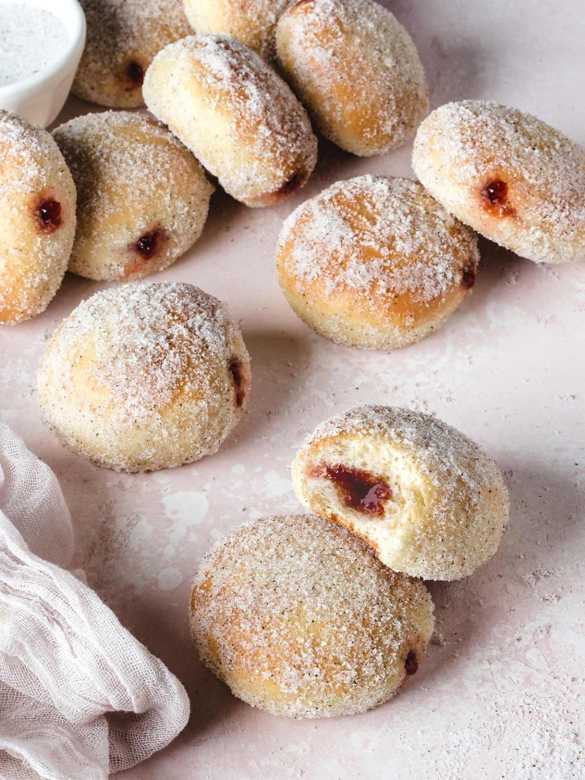 Baked strawberry jelly donuts on a light background.