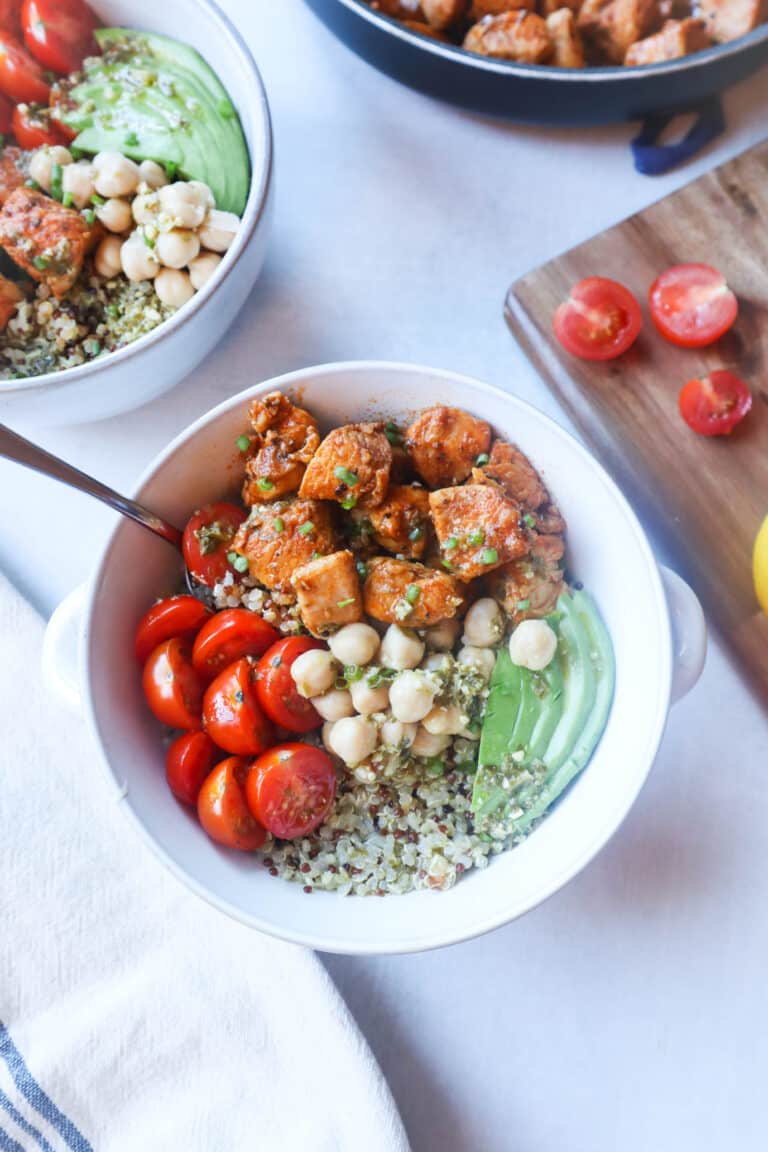 Bowl with pesto chicken, chick peas, tomatoes, and quinoa.